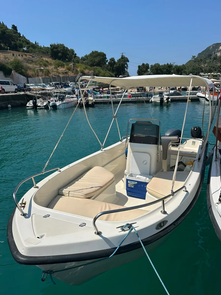 The Nemo moored at the port, with a sun canopy, cushioned seating and a coolbox on board.